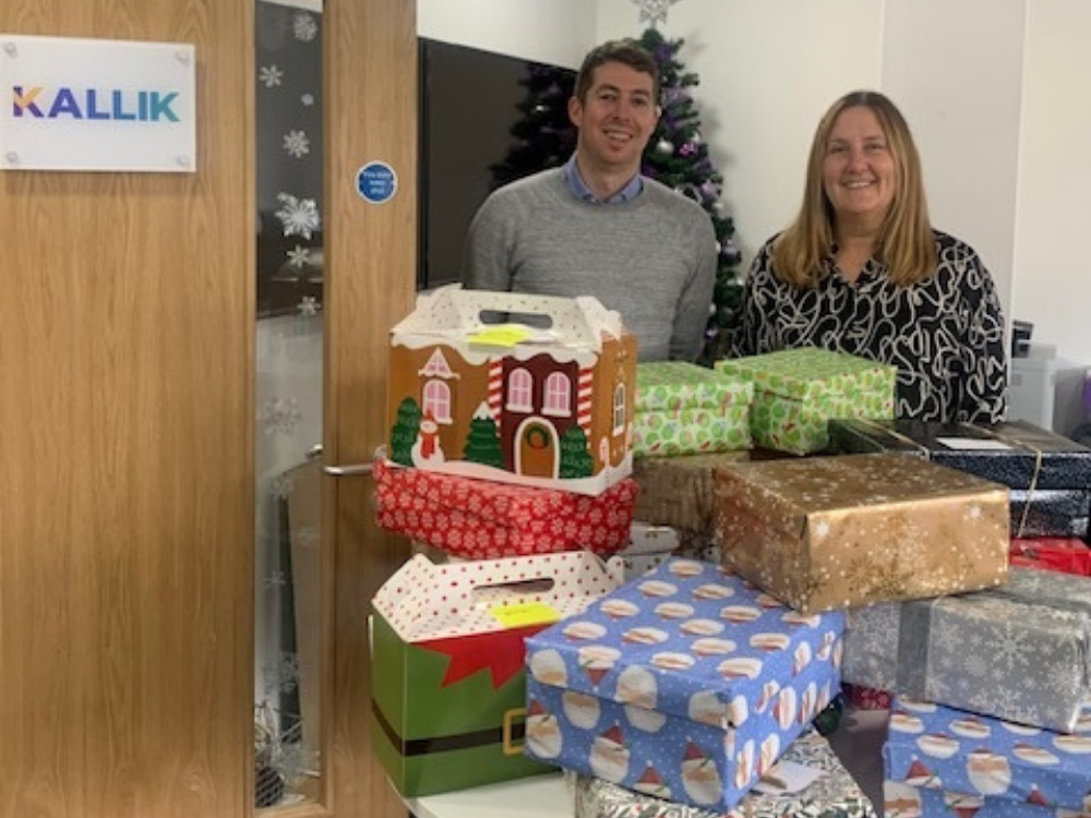 Sarah Wood and Alex Bertrand with Christmas wrapped shoeboxes