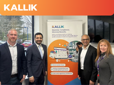 Four people stood in front of Kallik branding in the office